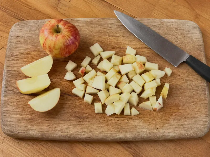 Apple diced into small pieces for an apple cinnamon protein yogurt bowl.