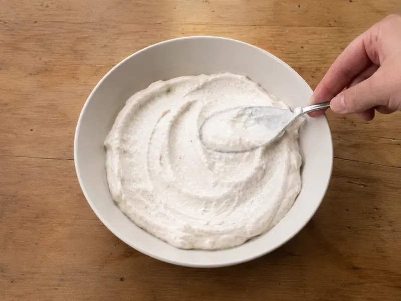 Apple cinnamon protein yogurt mixture spooned into a serving bowl.