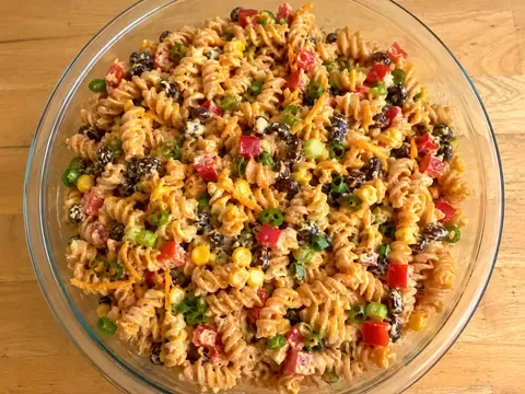 BBQ ranch pasta salad with pasta, corn, black beans, red bell pepper, cheddar cheese, green onions, and creamy dressing.