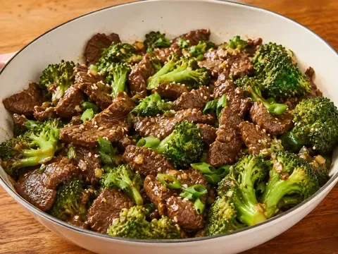 Beef and broccoli skillet with tender sliced beef, bright broccoli, green onions, sesame seeds, and savory sauce.