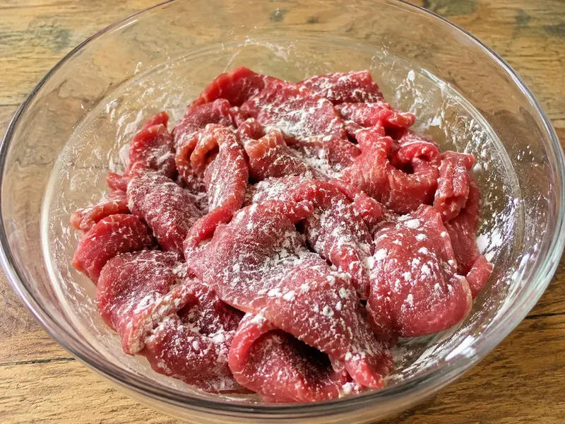 Thinly sliced beef tossed with cornstarch before cooking beef and broccoli.