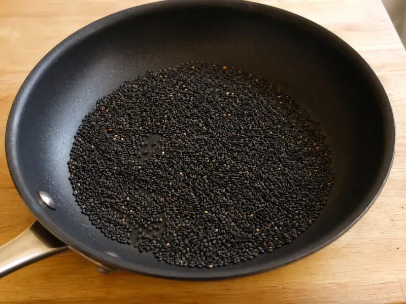 Black sesame seeds toasted in a skillet until fragrant.