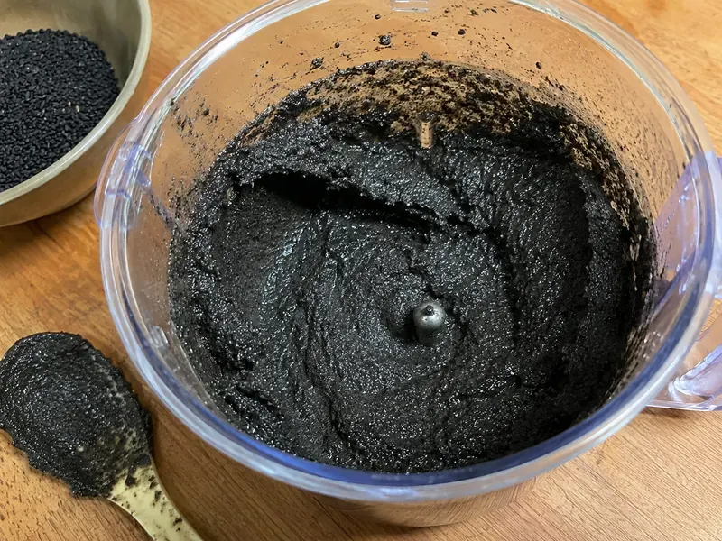 Black sesame seeds blended into a dark nutty sesame paste.