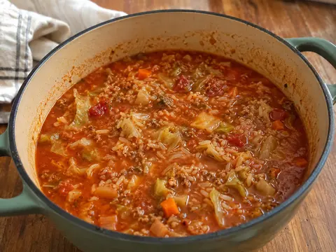 Cabbage Roll Soup with ground beef, cabbage, rice, carrots, herbs, and tomato broth in a soup bowl.