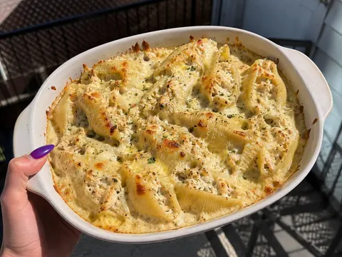 Chicken Alfredo Stuffed Shells with jumbo pasta shells, chicken filling, Alfredo sauce, mozzarella, and parmesan.