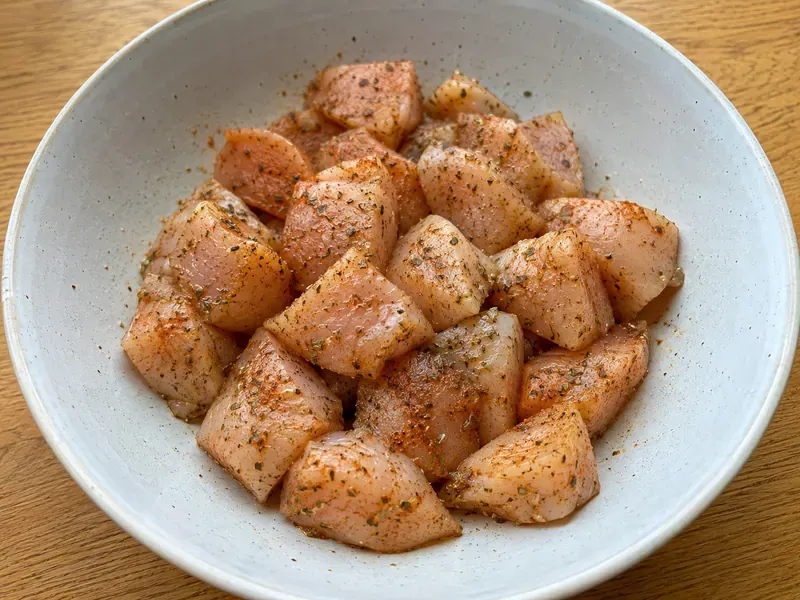 Chicken breast pieces seasoned with paprika, garlic powder, oregano, salt, and pepper.