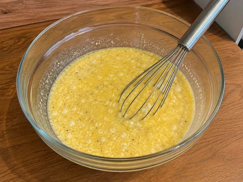 Eggs, egg whites, cottage cheese, and seasonings whisked together in a bowl.