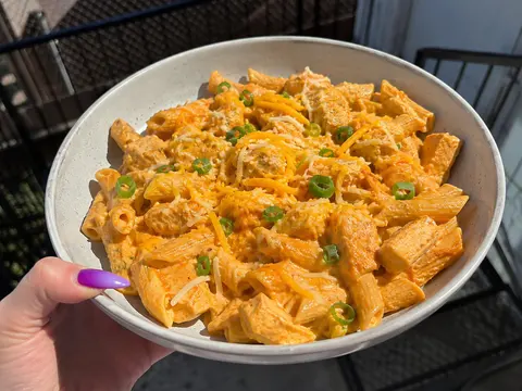 Creamy Buffalo Chicken Pasta with tender chicken, pasta, creamy buffalo sauce, melted cheese, and green onions.
