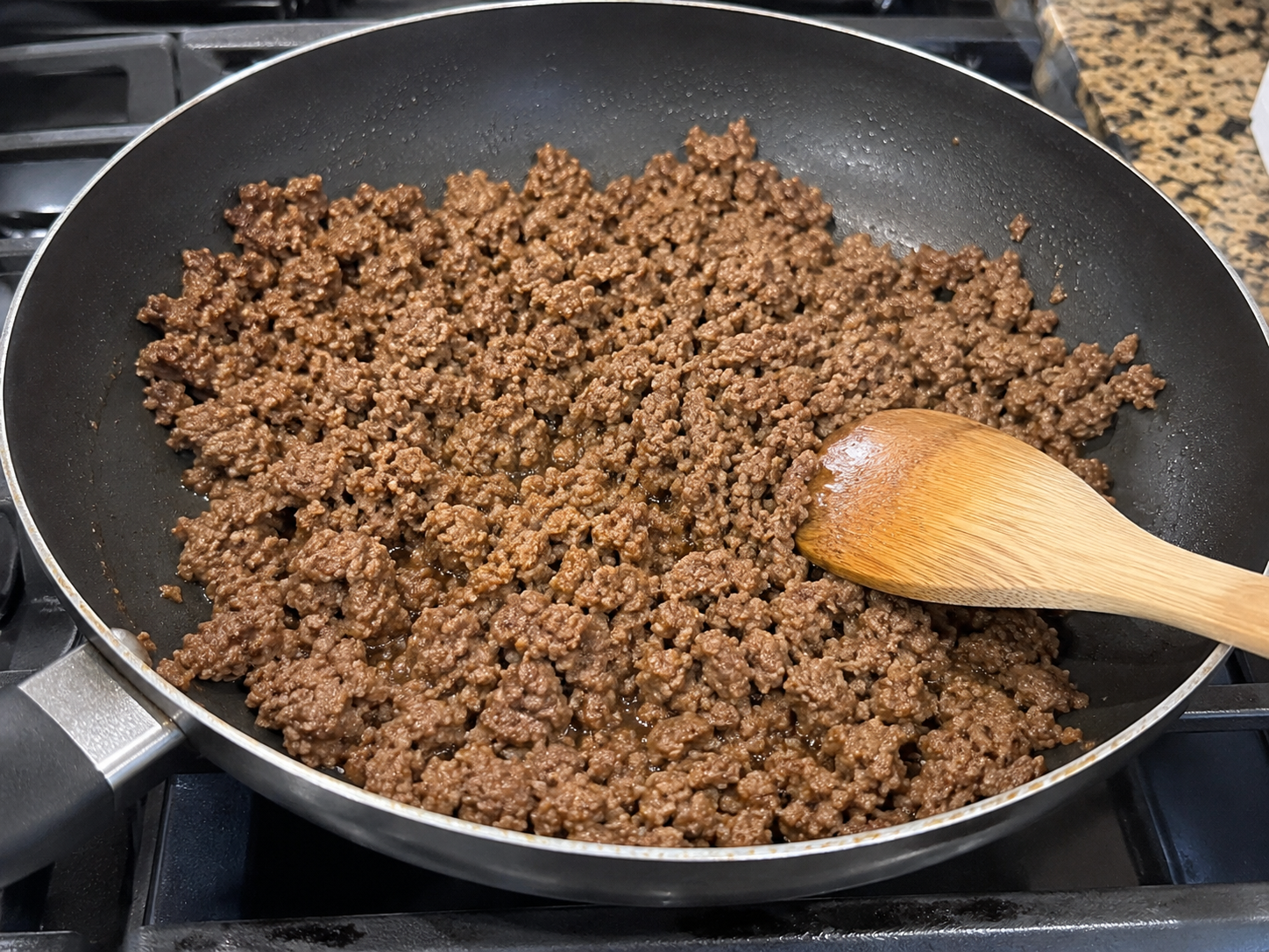 Lean ground beef cooking in a skillet for cabbage taco wraps.