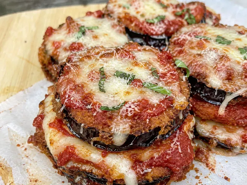 Crispy Eggplant Parmesan Stacks layered with marinara, mozzarella, parmesan, and basil.