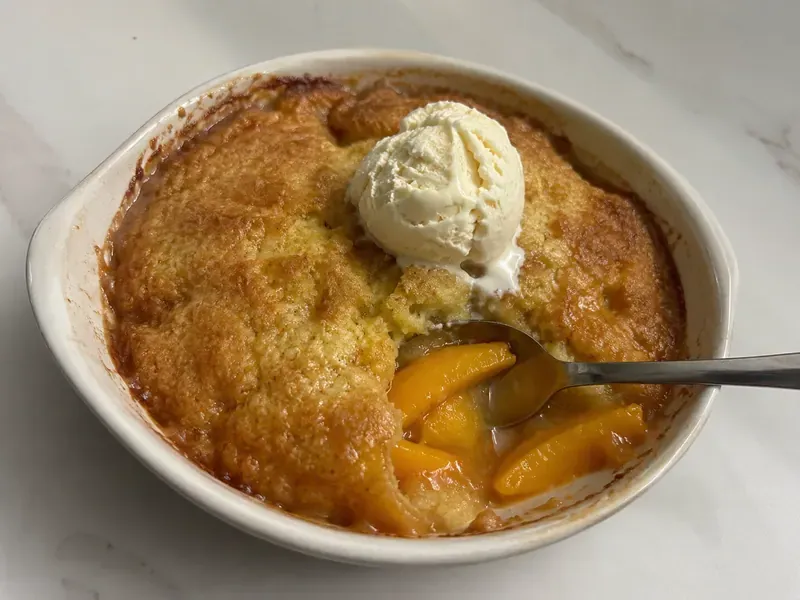 Easy Peach Cobbler baked until golden with juicy peach filling and a buttery topping.