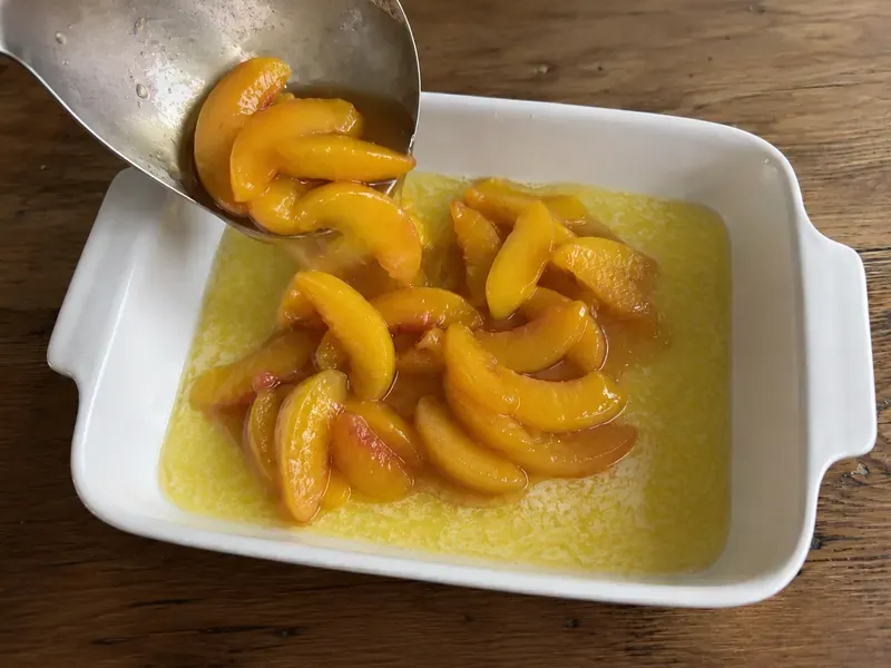 Sweetened peaches spooned over cobbler batter.