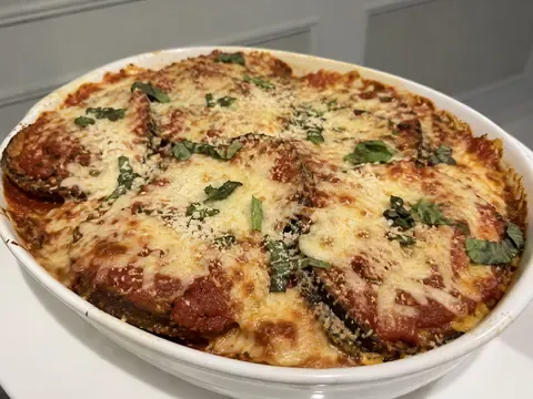 Eggplant Parmesan baked with marinara, melted mozzarella, parmesan, and fresh basil.