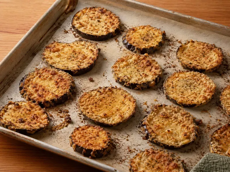 Breaded eggplant slices baked on a tray until crisp and golden.