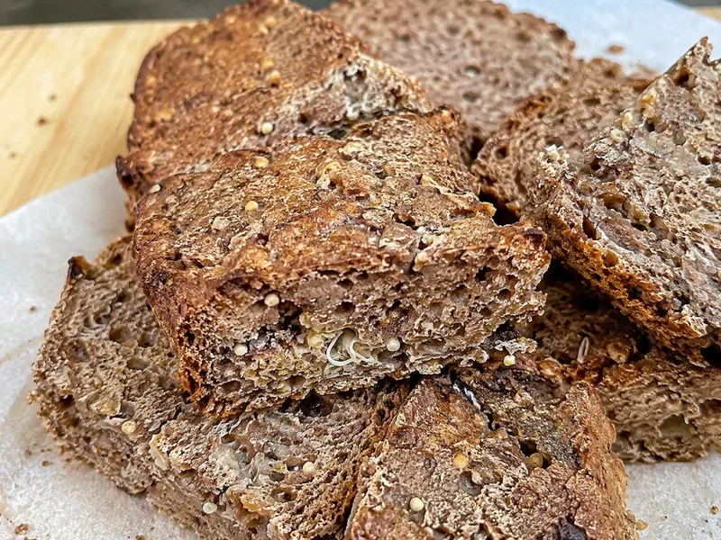 Ezekiel Bread Recipe with sliced sprouted grain bread showing a dense whole-grain crumb and browned crust.