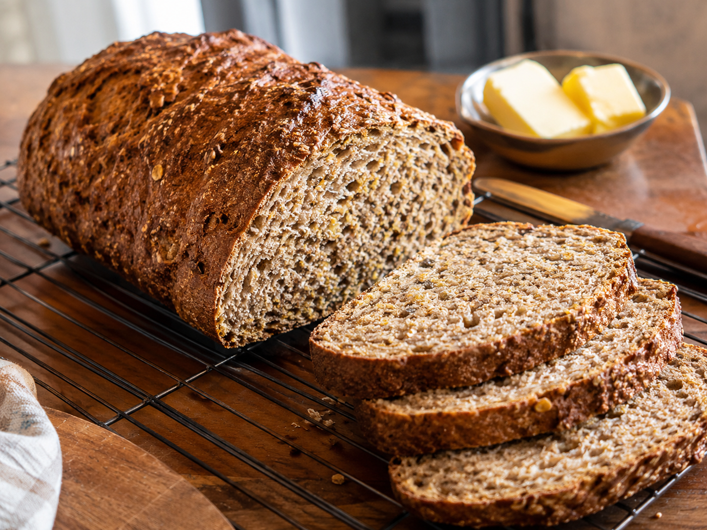 Finished Ezekiel bread loaf sliced to show a hearty whole-grain crumb.