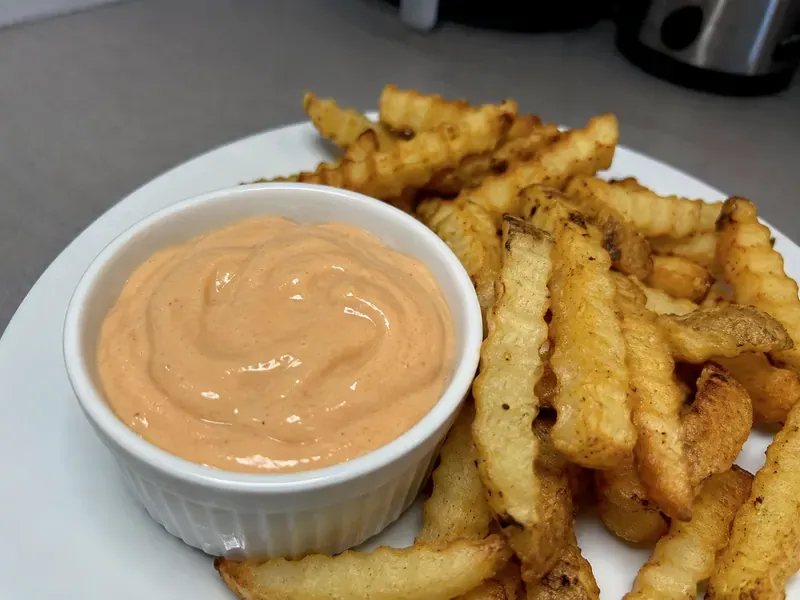 Fry Sauce Recipe with creamy pink-orange dipping sauce in a bowl served with fries.