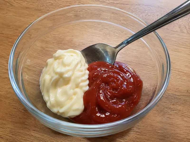 Mayonnaise and ketchup added to a small bowl for fry sauce.
