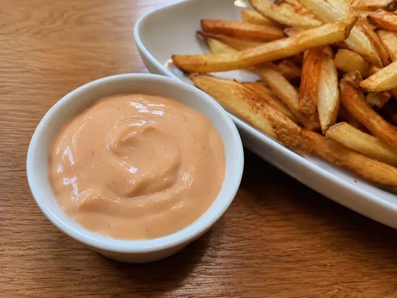 Fry sauce served in a ramekin with golden fries for dipping.