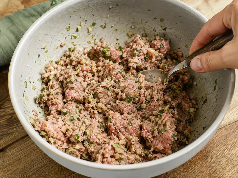 Ground turkey mixed with garlic, onion, herbs, and spices for kofta.
