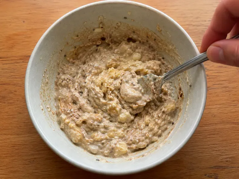 Greek yogurt mixed with mashed banana, oats, peanut butter, chia seeds, cinnamon, and honey.