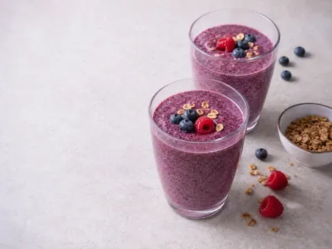 High Fiber Berry Smoothie final image showing a thick purple berry smoothie in clear glasses with a creamy texture, berry specks, optional fresh berries or granola, and a realistic breakfast setup.