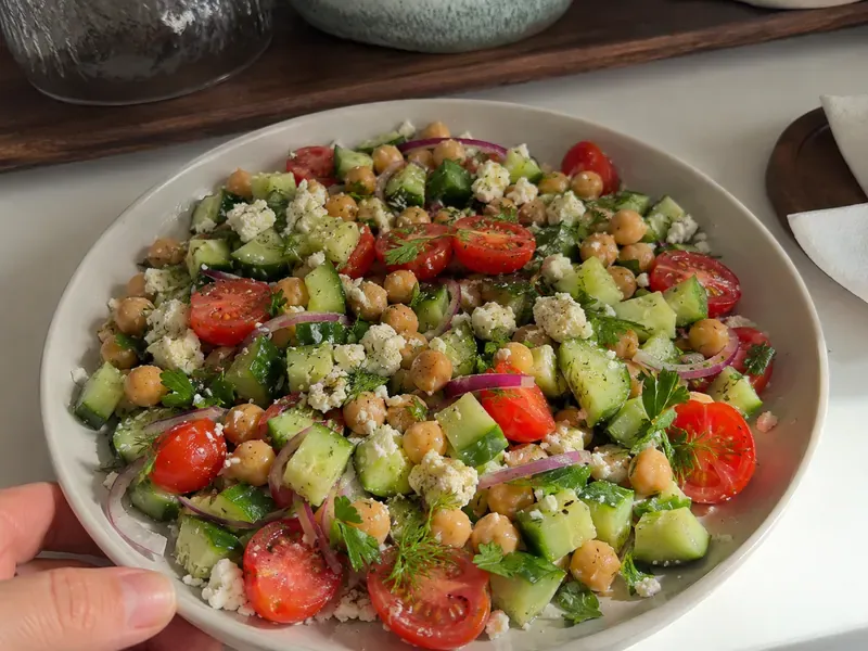 High-Fiber Chickpea Cucumber Salad with Lemon Feta in a bowl with tomatoes, herbs, and lemon dressing.