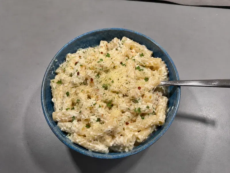 High protein cottage cheese Alfredo pasta with creamy sauce, parmesan, parsley, and tender pasta.
