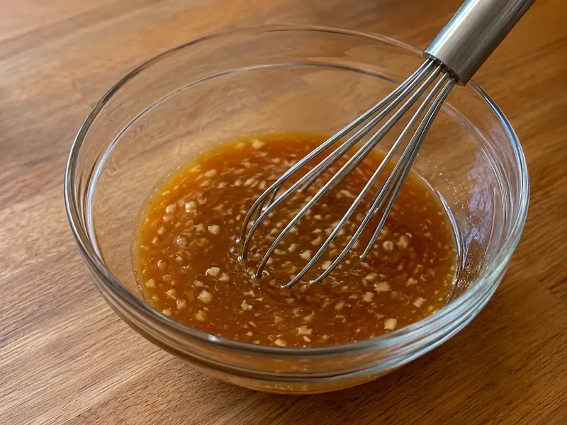 Honey garlic sauce mixed in a small bowl with soy sauce, garlic, honey, vinegar, cornstarch, and water.