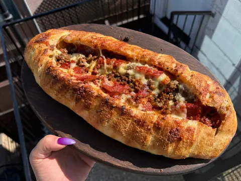 Meat Lovers Stuffed Pizza Bread filled with pepperoni, sausage, ground beef, marinara, and melted mozzarella.