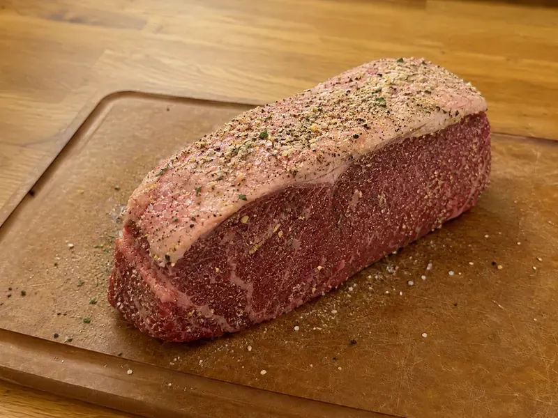 New York strip roast rubbed with olive oil, salt, pepper, garlic powder, and onion powder.
