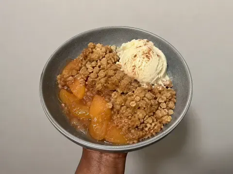 Peach Crumble with juicy baked peaches and a golden buttery crumb topping.