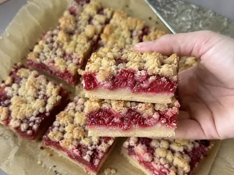 Raspberry Crumble Bars cut into squares with a golden crumble topping and bright raspberry filling.