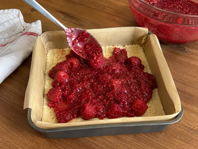 Raspberry filling made with berries, jam, sugar, cornstarch, and lemon juice.