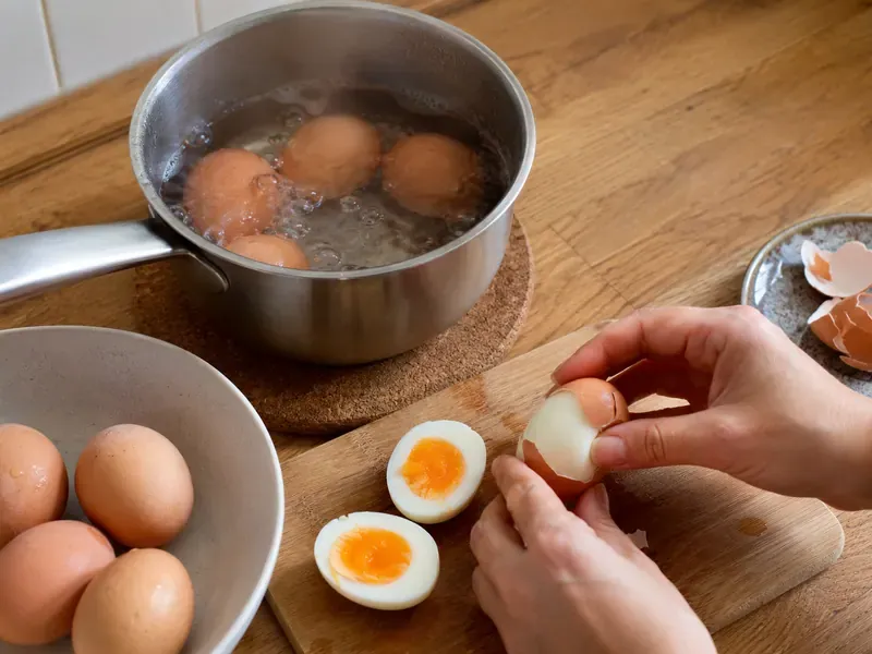 Eggs boiled and peeled for a smoked salmon cottage cheese breakfast bowl.