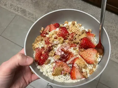 Strawberry cheesecake cottage cheese bowl with strawberries, graham cracker crumbs, and a creamy cottage cheese base.