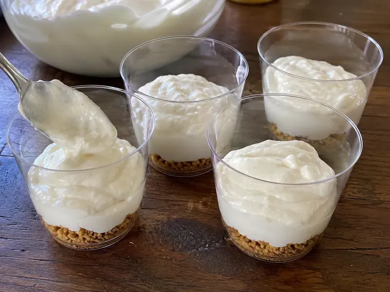 Clear dessert cups layered with pretzel crumbs and creamy filling.