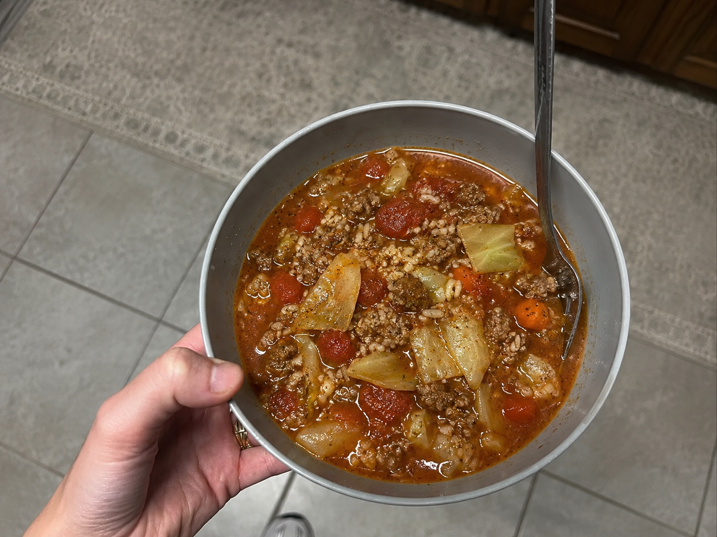 Stuffed cabbage roll soup with ground beef, cabbage, tomatoes, rice, carrots, herbs, and tomato broth.