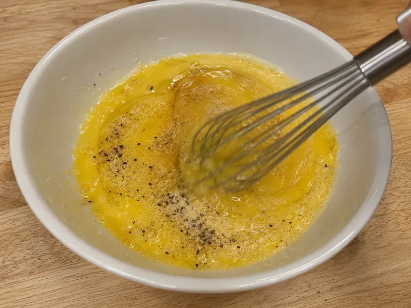 Eggs and egg whites whisked with salt, black pepper, and garlic powder.